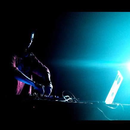 DYLUX on the decks, lit by a blue spotlight